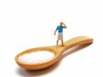 Miniature Woman Standing On A Wooden Spoon And Thinking Of Sugar, Diet, Fat And Diabetes. Health Care Concept Stock Photo