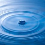 Water Drop Impact With Water Surface, Causing Rings On The Surface Stock Photo