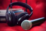 Microphone And Head Phone On Red Sofa Leather Use For Entertainm Stock Photo