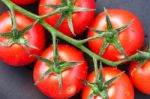 Close-up Of Some Ripe Tomatoes On The Vine Stock Photo