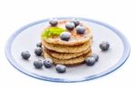 Pile Of Pancakes With Blueberries Sprinkled With Icing Sugar Stock Photo