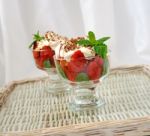 Strawberries With Biscuit Pieces With Mint Whipped Cream Under Stock Photo