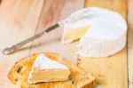 Camembert Cheese With Cut Wedge On Toasted Bread Slice And Vinta Stock Photo