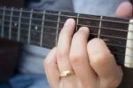 Guitarist Hand Playing Acoustic Guitar Stock Photo