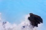 Milky White And Blue Water Between The Lava Stones Covered With Moss Stock Photo