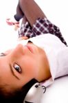 Side Pose Of Woman On Floor Listening To Music Stock Photo