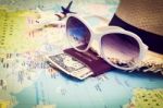 Sunglasses, Passport, Money, Hat And Aircraft On The World Map Stock Photo