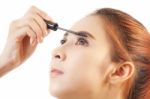 Woman Applying Mascara Stock Photo