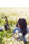 Young Woman With Mountain Bike Stretched On The Field Stock Photo