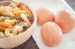 Fresh Eggs On Wooden Plate With Fusili Stock Photo