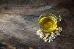 Chamomile Tea And Chamomile Flower On Old Wooden Table Stock Photo