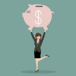 Business Woman Lifting A Piggy Bank Stock Photo