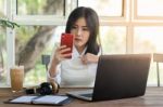 Young Businesswoman Working In Coffee Shop Stock Photo