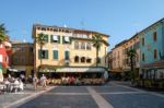 People Relaxing In A Square At Sirmione Lake Garda Stock Photo