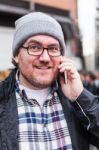 Hipster Traveler Young Man Talking On His Smartphone Stock Photo