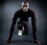 Athletic Man Running In Black Background Stock Photo