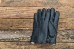 Winter Black Leather Gloves With Fur On Wooden Table Stock Photo