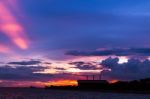 Factory Beside The Sea With Colorful Sunset Stock Photo