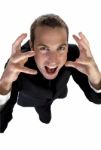 Young Businessman Shouting And Looking Upside Stock Photo