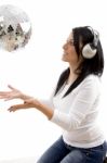 Side View Of Smiling Female Playing With Disco Mirror Ball Stock Photo