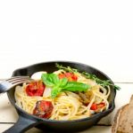 Spaghetti Pasta With Baked Cherry Tomatoes And Basil Stock Photo