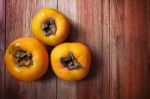 Persimmon Fruit On Wood Table Stock Photo