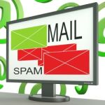 Mail And Spam Envelopes On Monitor Shows Online Messages Stock Photo