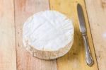 Camembert Cheese And Vintage Knife On Wooden Table Stock Photo