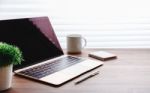 Office Table With Laptop And Pen Stock Photo