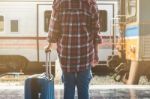 Young Asian Tourist With Luggage Waiting Train In Station Stock Photo