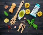 The  Pasta On Black Wooden Background. Yellow Italian Pasta With Stock Photo