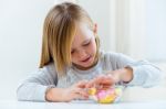 Beautiful Child Eating Sweets At Home Stock Photo