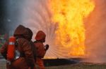 Firefighters Putting Out Fire Stock Photo