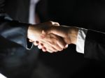 Handshaking business people Stock Photo