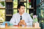 Business Man Using Mobile Phone While Sitting In The Coffee Shop Stock Photo