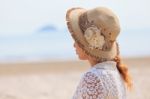 Woman Looking Into The Sea Stock Photo