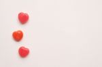 Three Red Valentine's Day Heart Shape Candy Line On White Paper Background. Love Concept. Minimalism Style. Knolling Top View Stock Photo