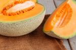 Melon Sliced On Wooden Stock Photo