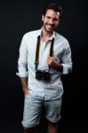 Young Tourist Man With Vintage Photo Camera. Isolated On Black Stock Photo