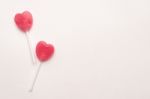 Two Pink Valentine's Day Heart Shape Lollipop Candy On Empty White Paper Background. Love Concept. Knolling Top View. Minimalism Colorful Hipster Style Stock Photo