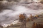 Farm On Hills In The Mountains. Waves Of Mist In A Forest Stock Photo