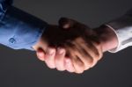 Handshake Handshaking In Dark With Low Light Stock Photo