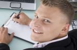 Smiling Ceo Writing on clipboard Stock Photo