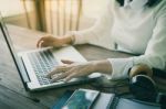 Woman Hand Typing On Laptop Keyboard Stock Photo