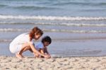 Asian Mom And Son On Beach Stock Photo