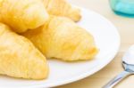 Croissant Or Bread On White Dish On Wood Table And Glass And Spo Stock Photo