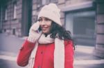 Woman In Red Coat And Wool Cap And Gloves With Smartphone In Han Stock Photo