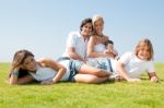 Happy Family Relaxing In Garden Stock Photo