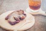 Pork Steak On Wooden Plate Stock Photo