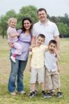 Happy Couple With Divine Kids Looking At You Stock Photo